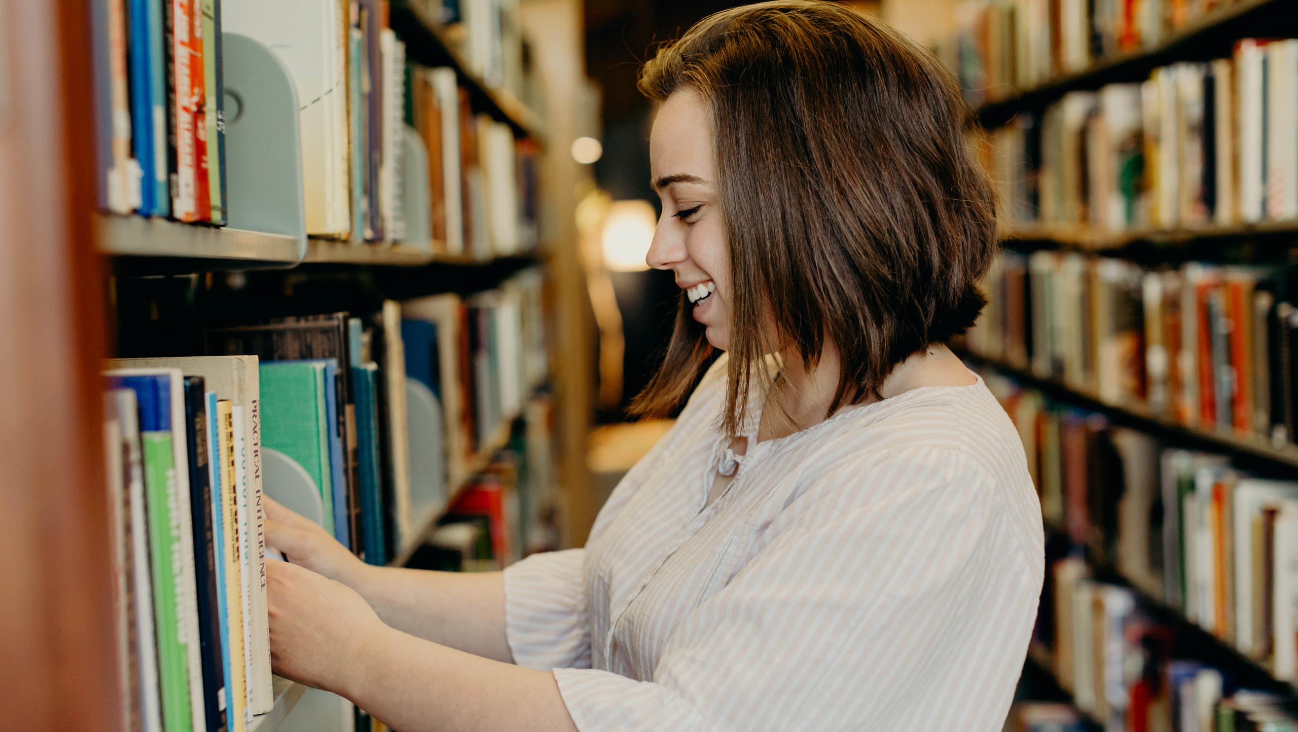 Student looking at books in the library